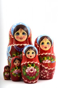 five traditional Russian matryoshka dolls on white background